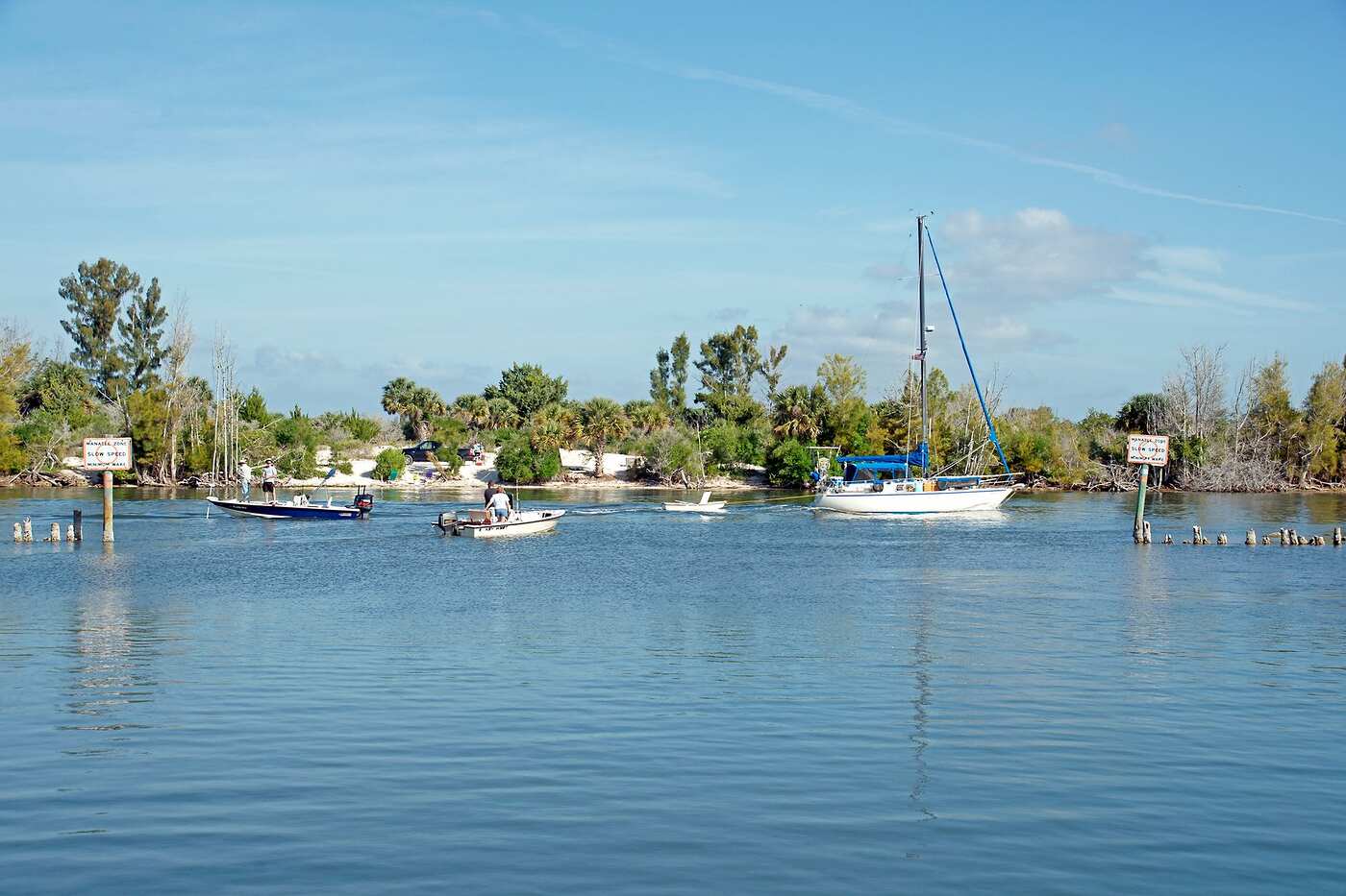 Boats on a Florida canal under a clear blue sky