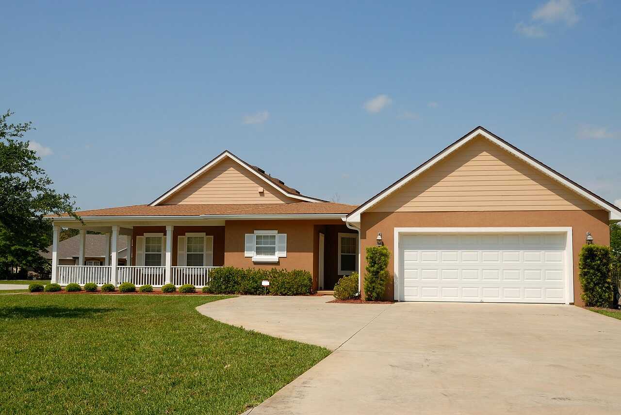 A single-story Florida house with a garage and a palm