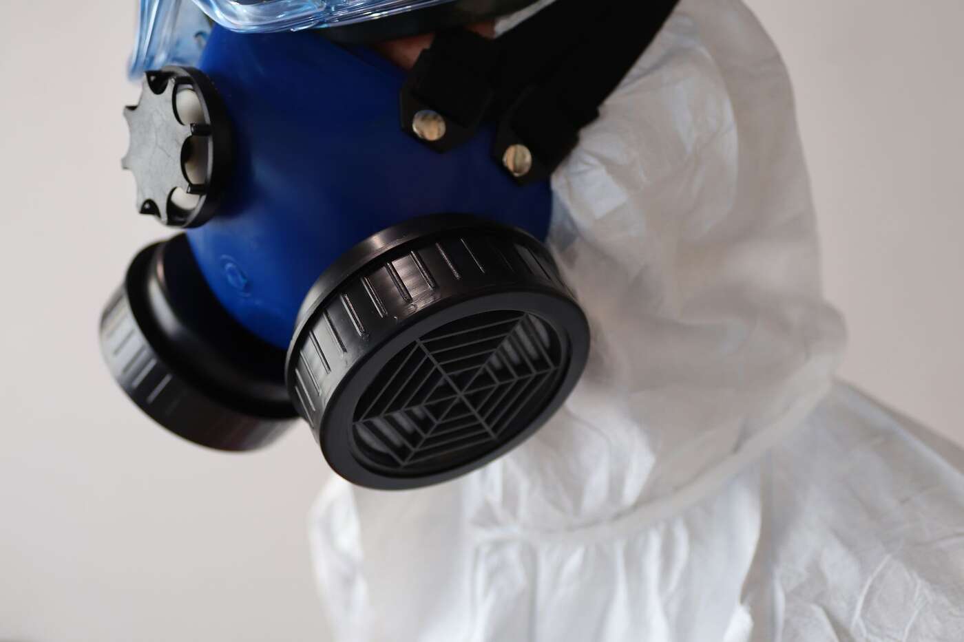 A respirator mask and a white protective suit