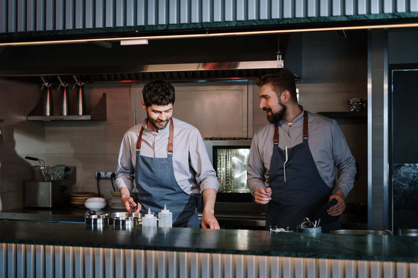 Two cooks working in a stainless steel kitchen