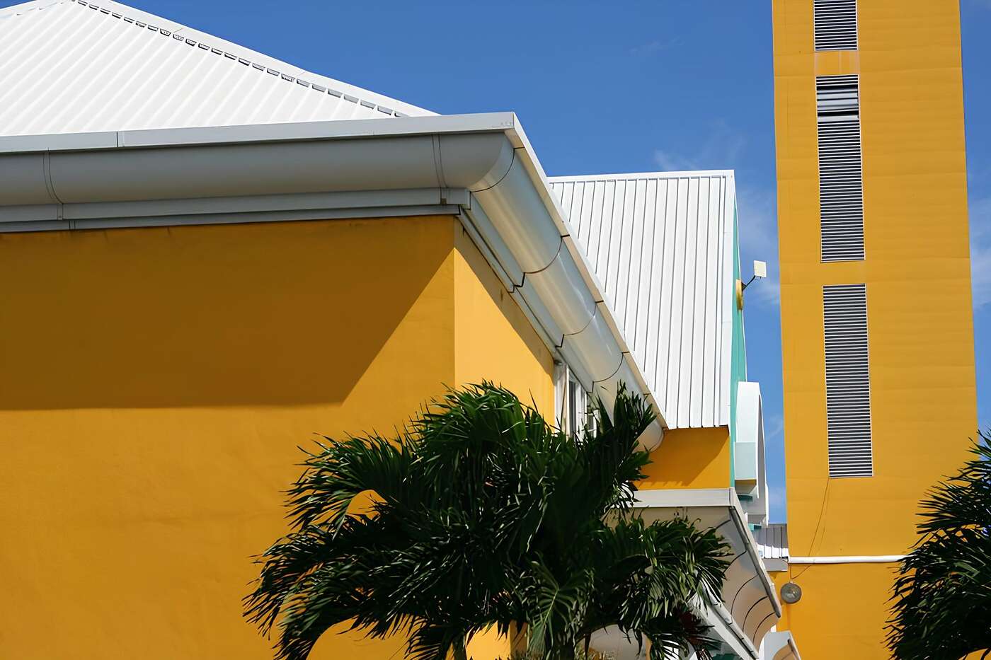 The eave of a yellow stucco building
