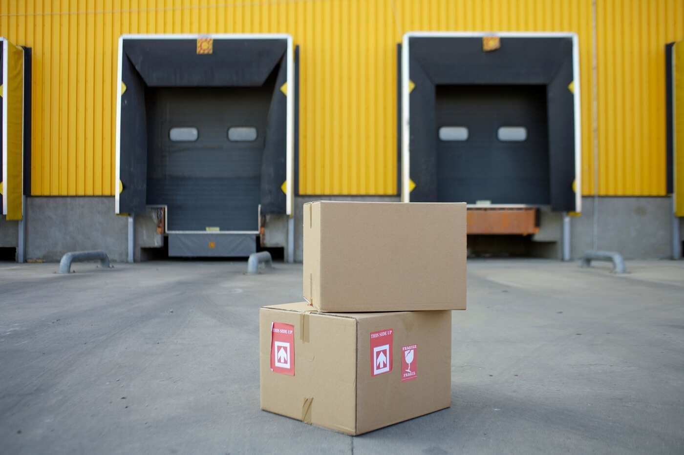 Cardboard boxes in front of warehouse loading dock doors